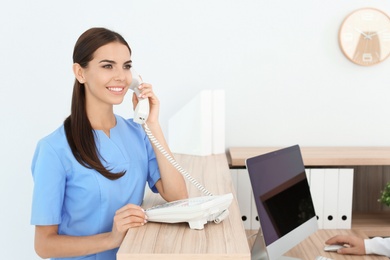 Photo of Female medical assistant at workplace in clinic. Health care service