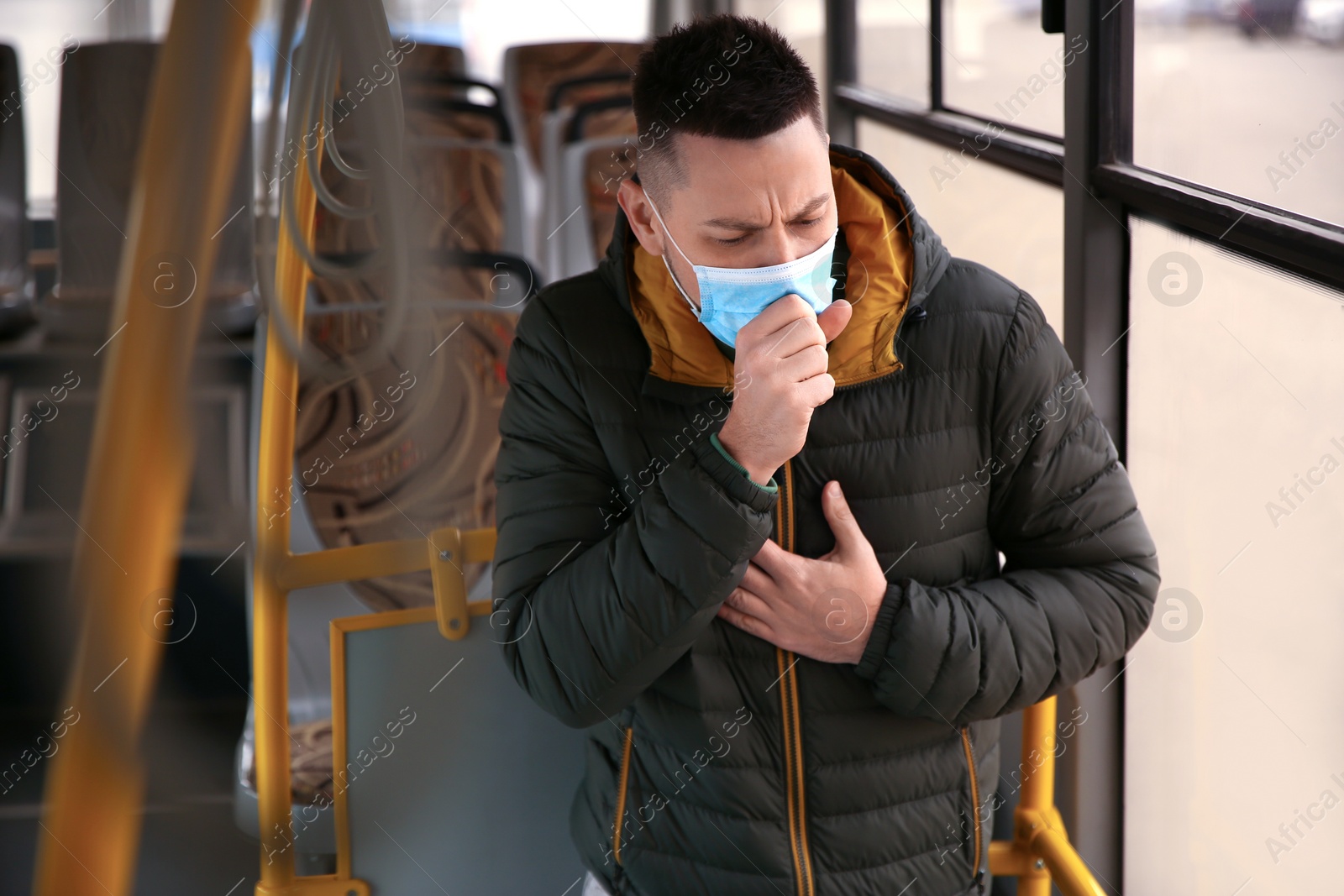 Photo of Man with disposable mask on bus. Virus protection