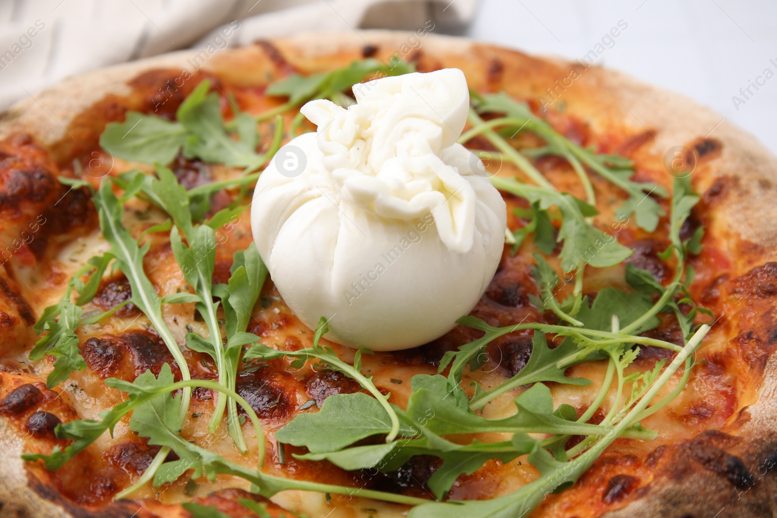 Photo of Delicious pizza with burrata cheese and arugula, closeup