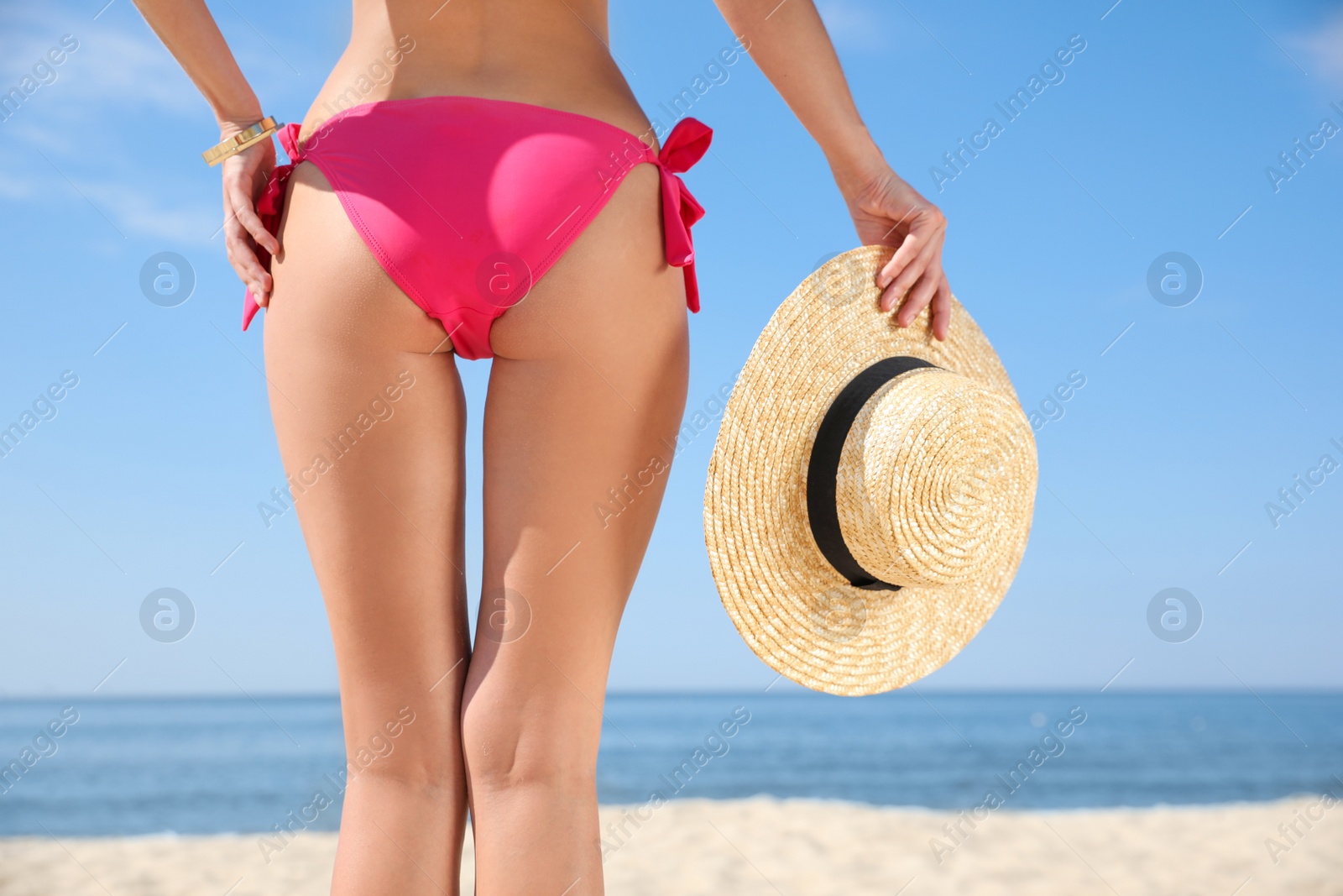 Photo of Young woman with beautiful body on beach, closeup