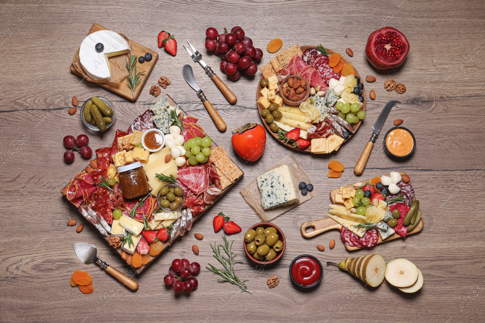 Photo of Assorted appetizers served on wooden table, flat lay
