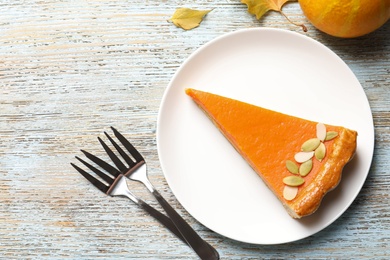 Photo of Flat lay composition with fresh delicious homemade pumpkin pie on wooden background
