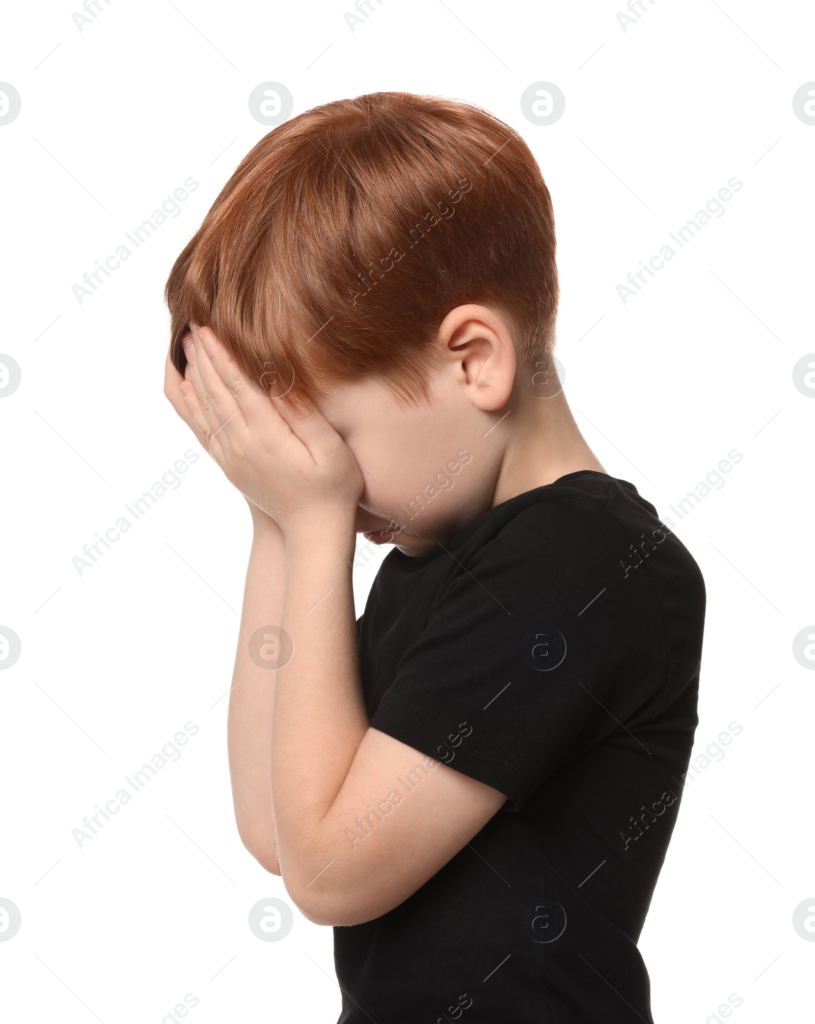 Photo of Boy covering face with hands on white background. Children's bullying