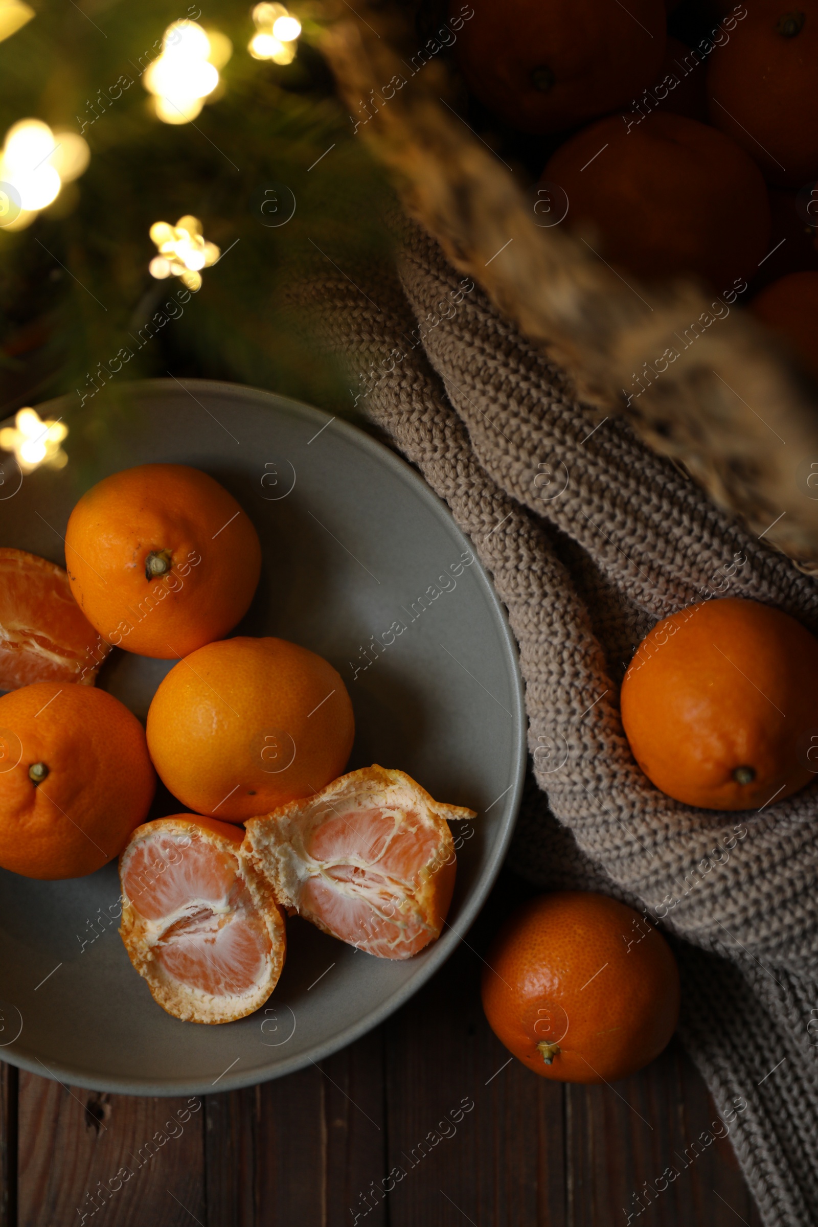 Photo of Fresh ripe tangerines and Christmas decor on wooden table, flat lay