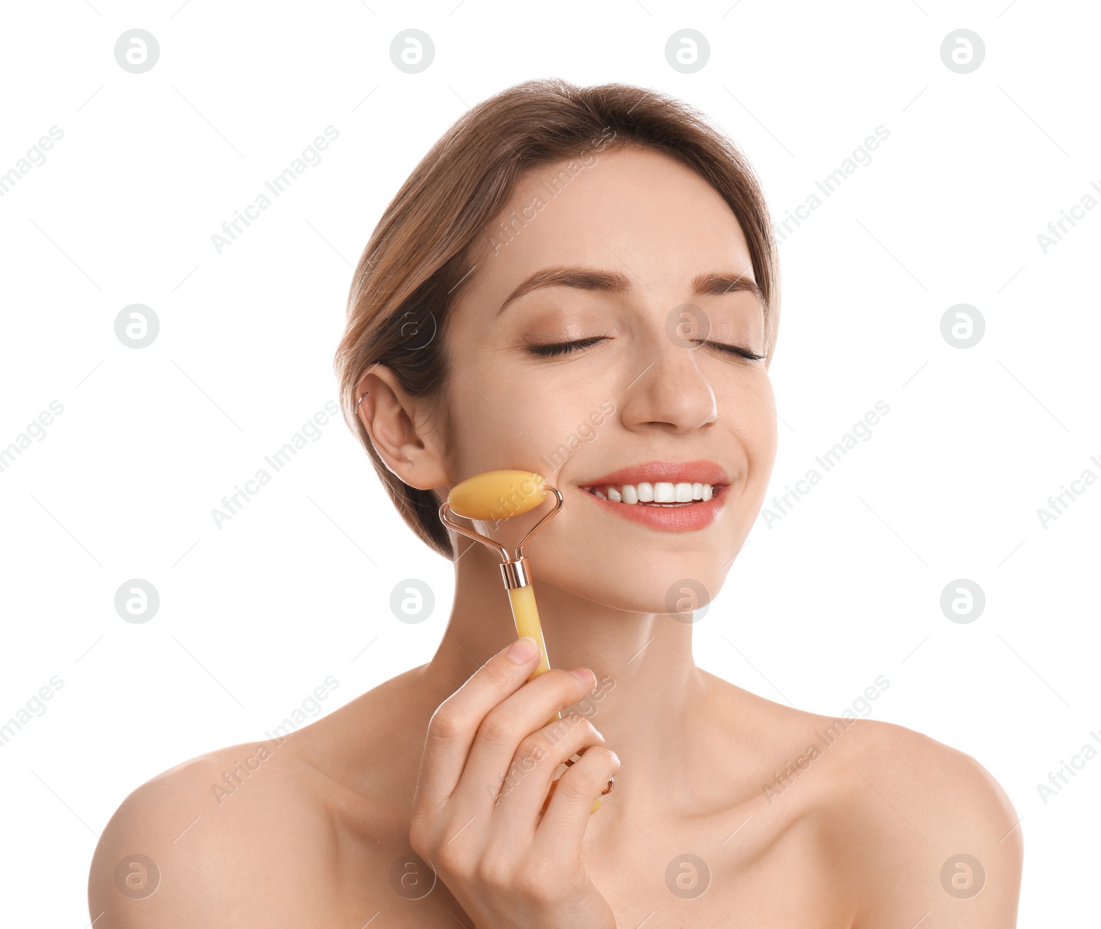 Photo of Young woman using natural jade face roller on white background