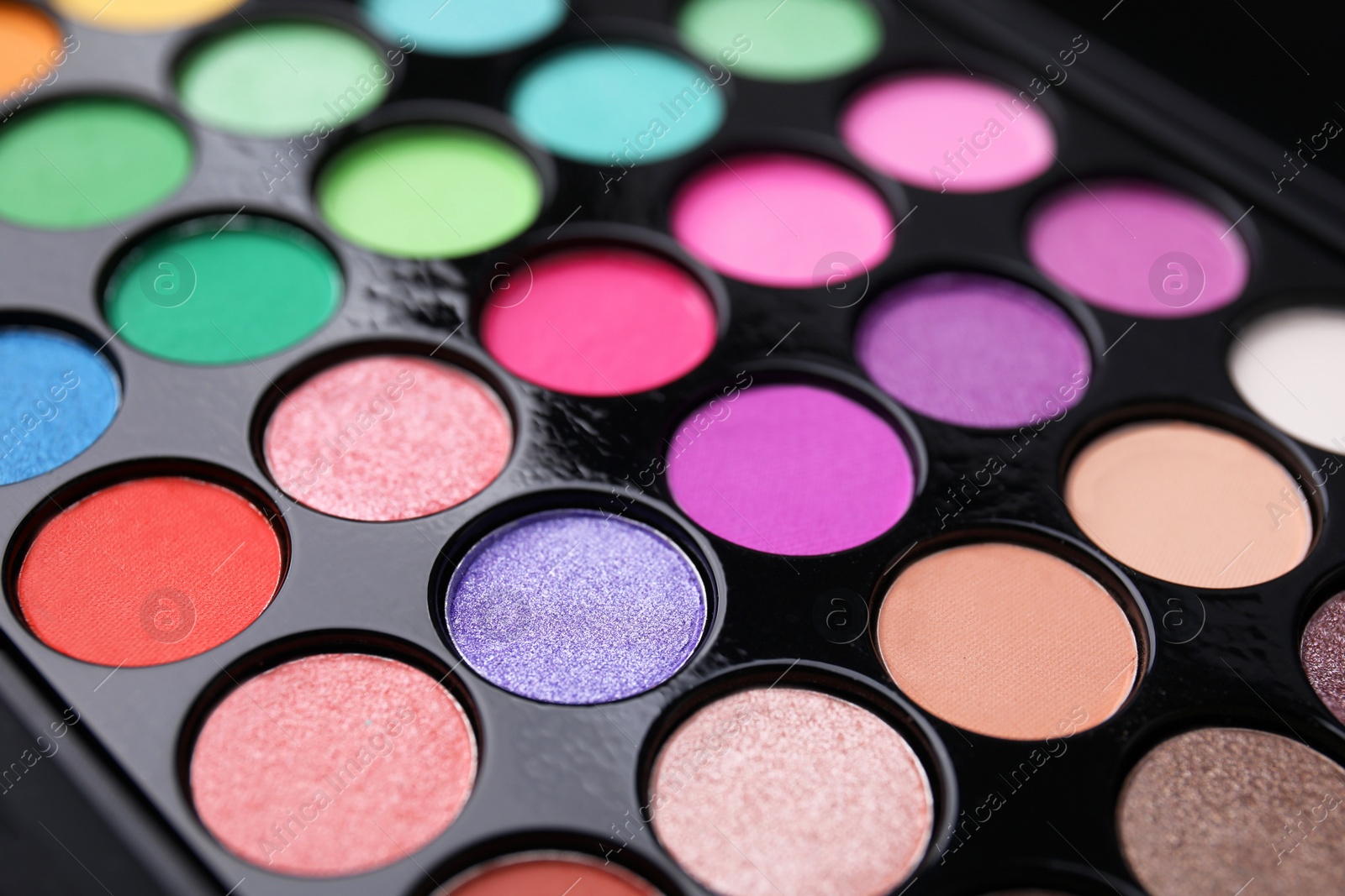 Photo of Beautiful eyeshadow palette as background, closeup. Professional cosmetic product