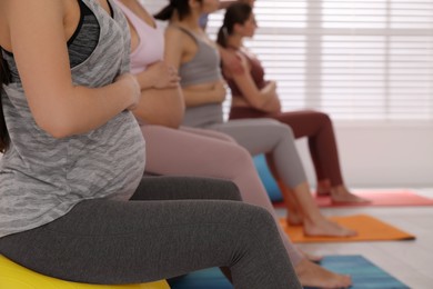 Photo of Group of pregnant women in gym, closeup. Preparation for child birth