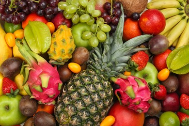 Assortment of fresh exotic fruits as background, top view