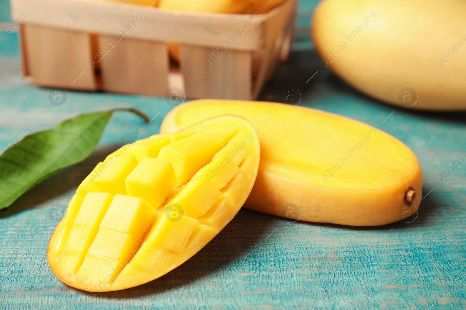 Photo of Fresh cut mango on color wooden table, closeup