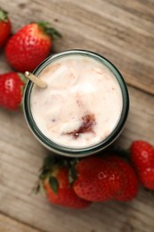 Tasty yoghurt with jam and strawberries on wooden table, top view