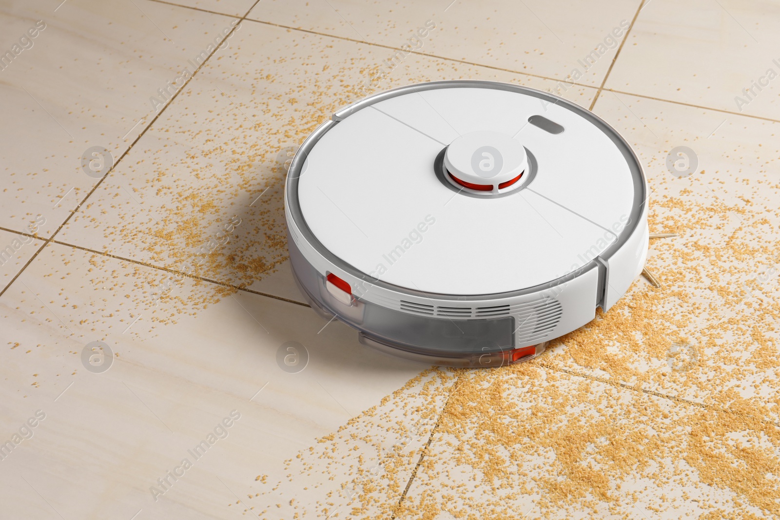 Photo of Robot vacuum cleaner removing dirt from floor in room