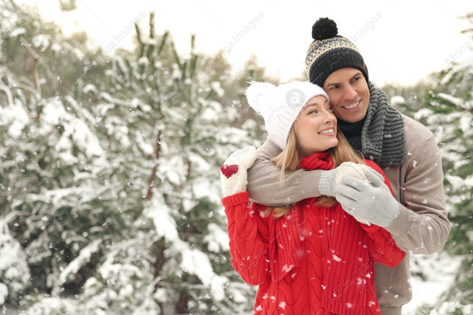 Photo of Beautiful happy couple in snowy forest on winter day