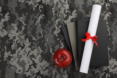 Photo of Books, apple and diploma on camouflage background, flat lay with space for text. Military education concept