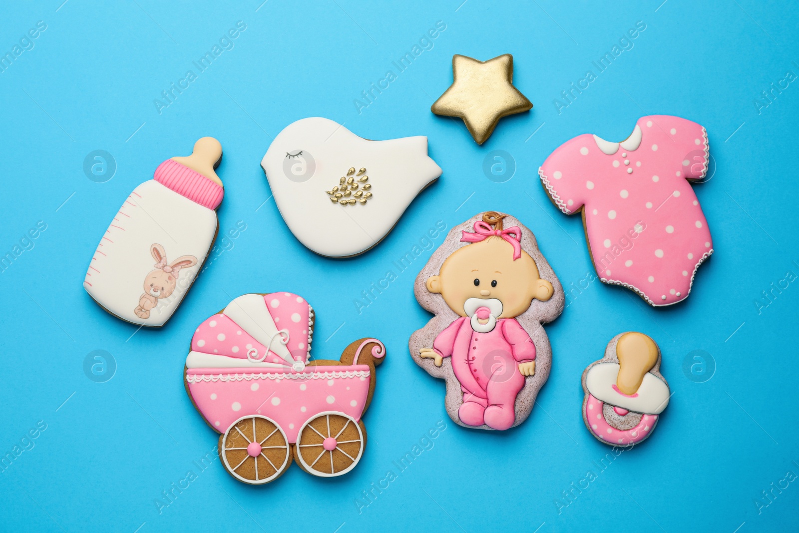Photo of Cute tasty cookies of different shapes on light blue background, flat lay. Baby shower party