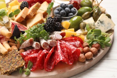 Different tasty appetizers on white wooden table, closeup