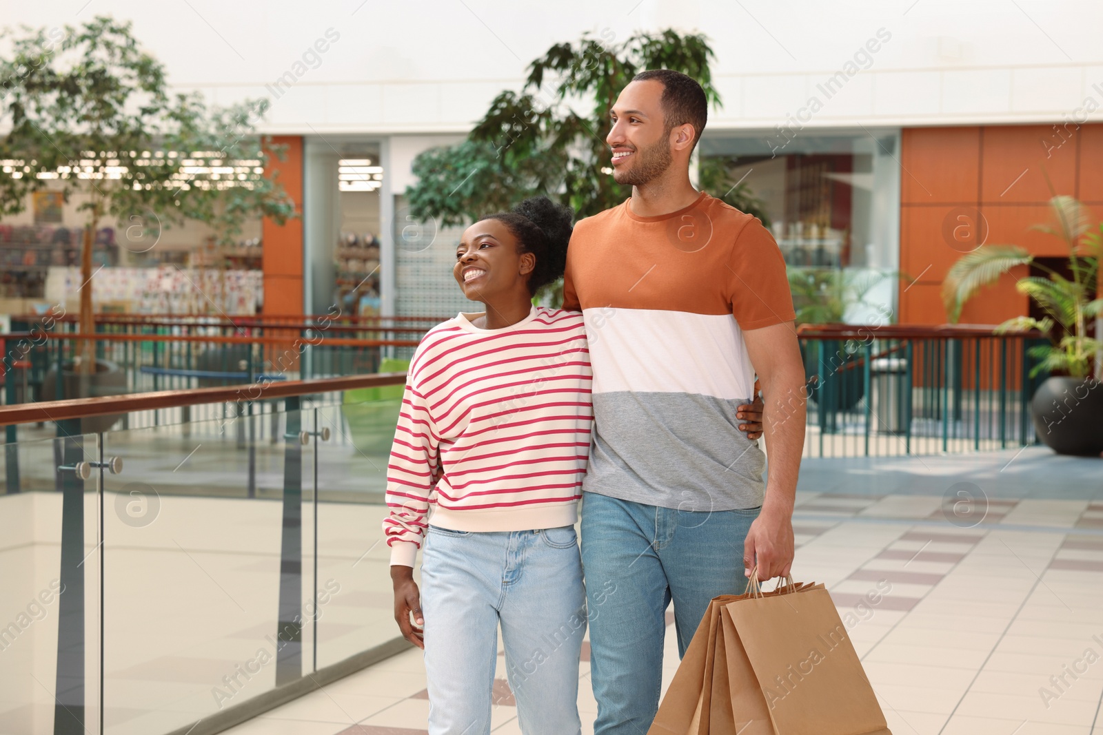 Photo of Family shopping. Happy couple with purchases in mall