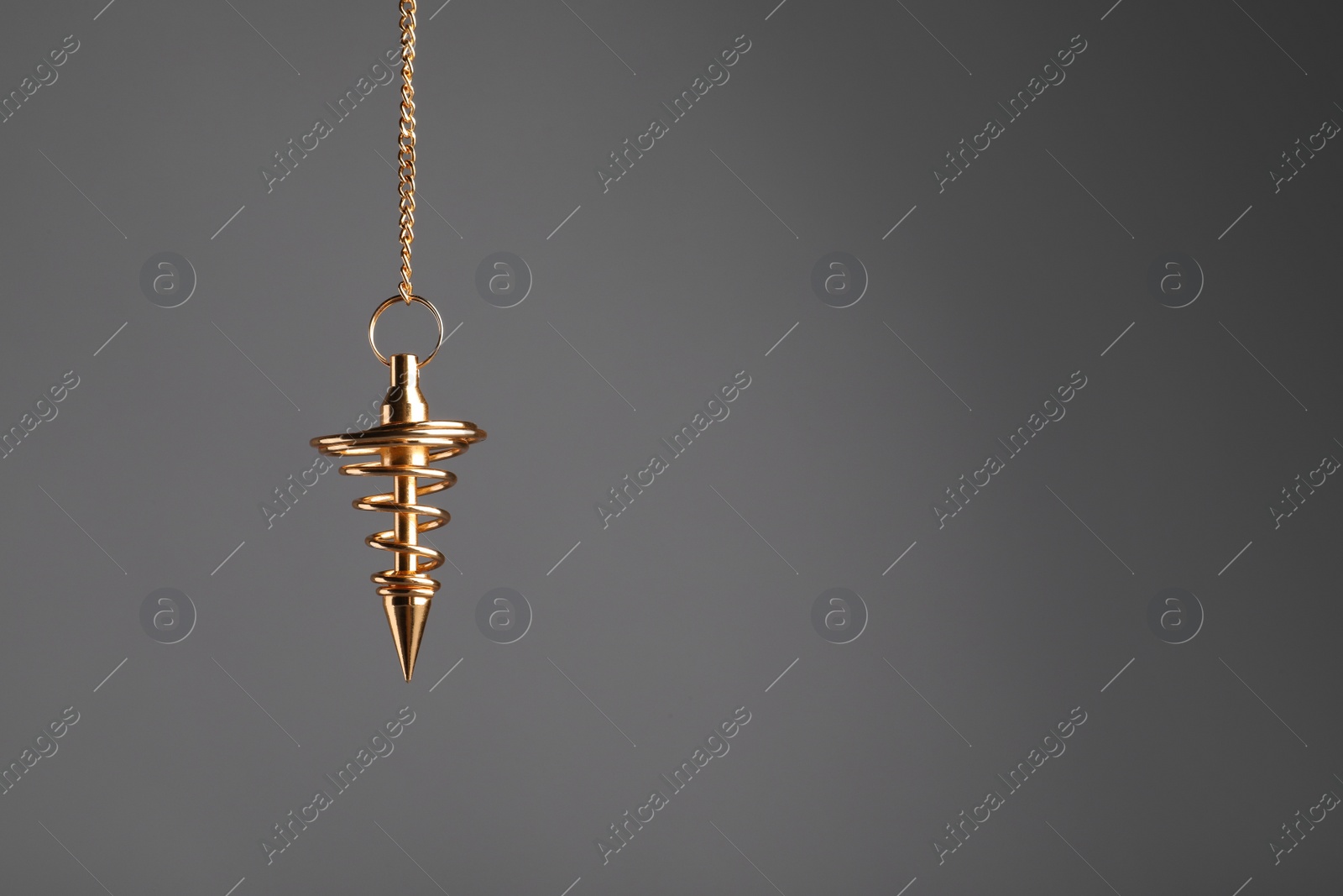 Photo of Stylish pendulum on grey background, space for text. Hypnotherapy session