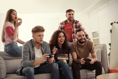Emotional friends playing video games at home