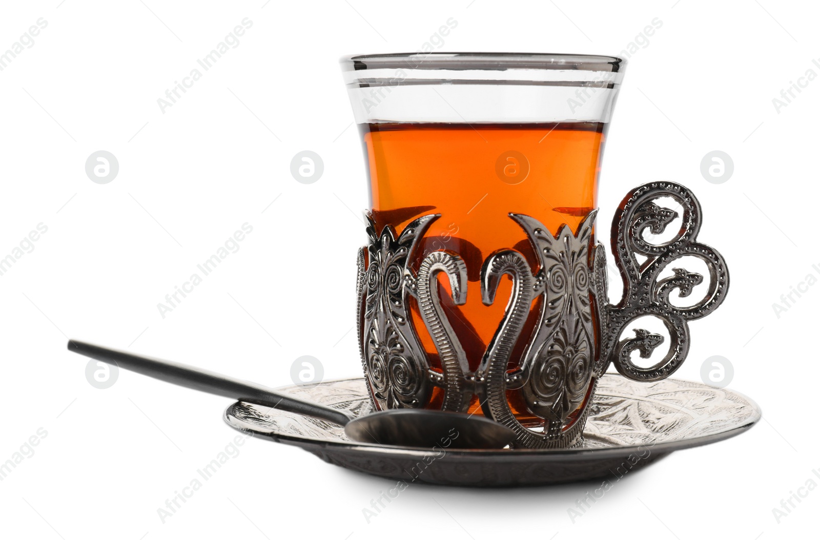 Photo of Glass of traditional Turkish tea in vintage holder isolated on white