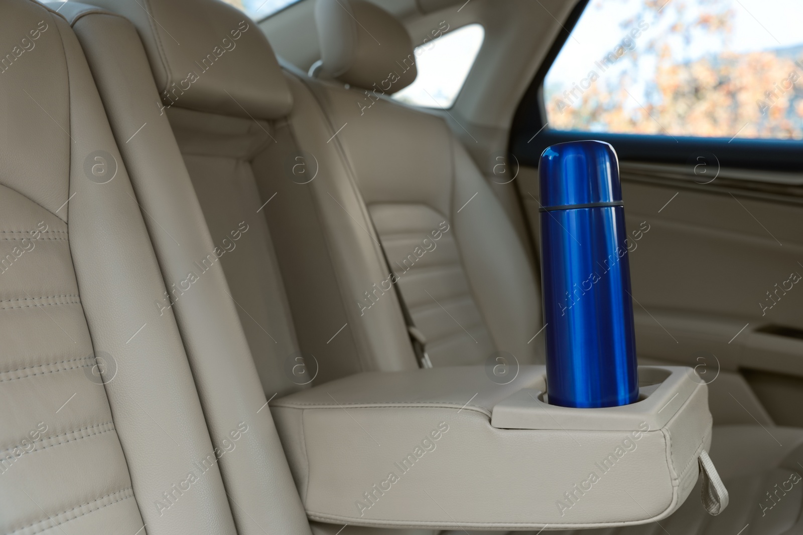 Photo of Blue thermos in holder inside of car