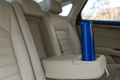 Photo of Blue thermos in holder inside of car