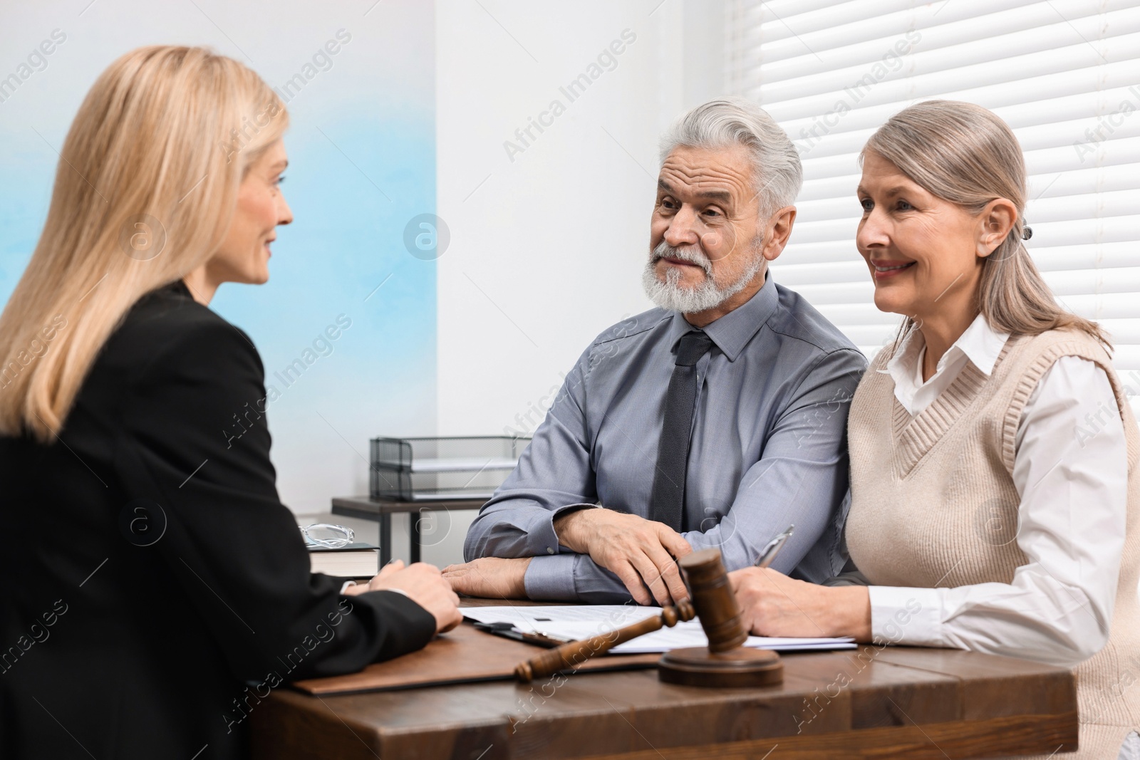 Photo of Senior couple having meeting with lawyer in office