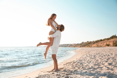 Photo of Romantic young couple having fun together on beach