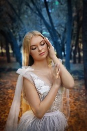 Photo of Beautiful girl wearing fairy dress in autumn forest