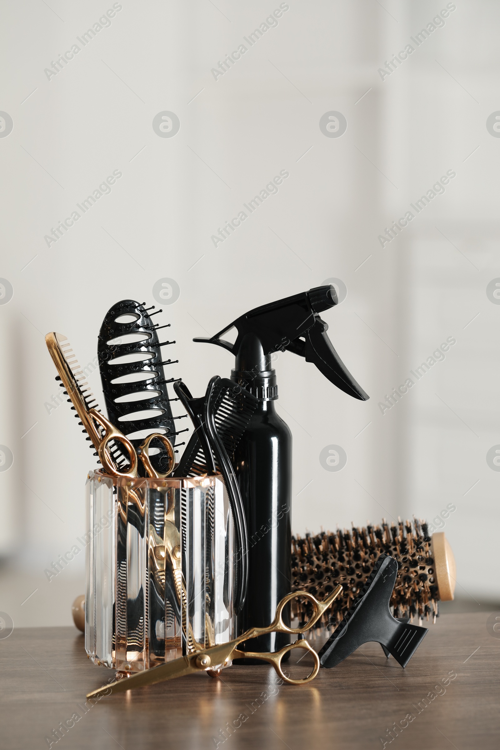 Photo of Set of hairdresser tools on table in salon