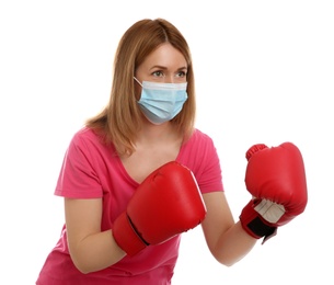 Photo of Woman with protective mask and boxing gloves on white background. Strong immunity concept