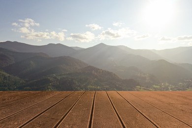 Empty wooden surface and beautiful view of mountain landscape with forest