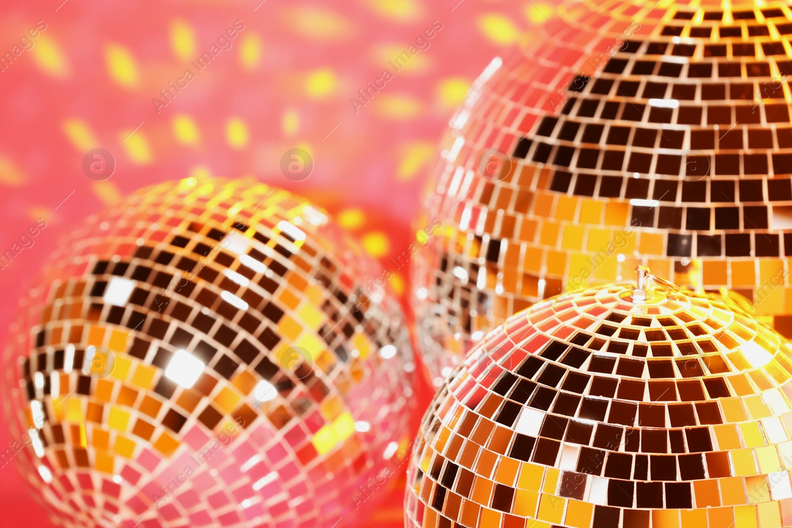 Photo of Many shiny disco balls on pink background
