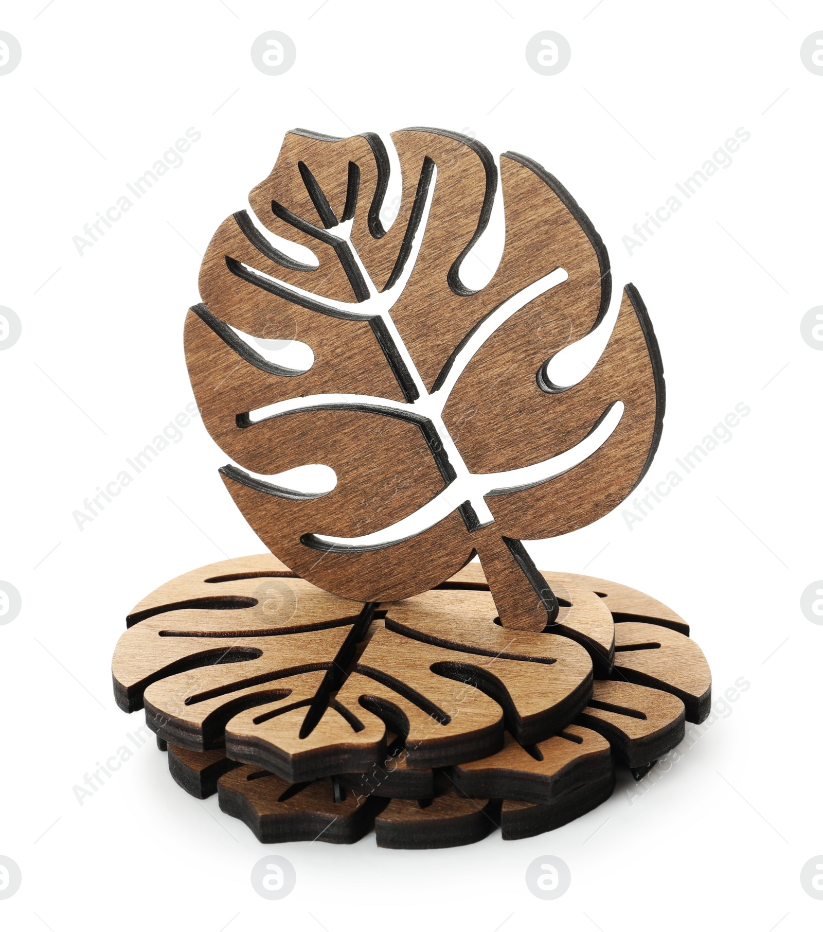 Photo of Leaf shaped wooden cup coasters on white background