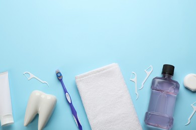 Photo of Flat lay composition with mouthwash and other oral hygiene products on light blue background. Space for text