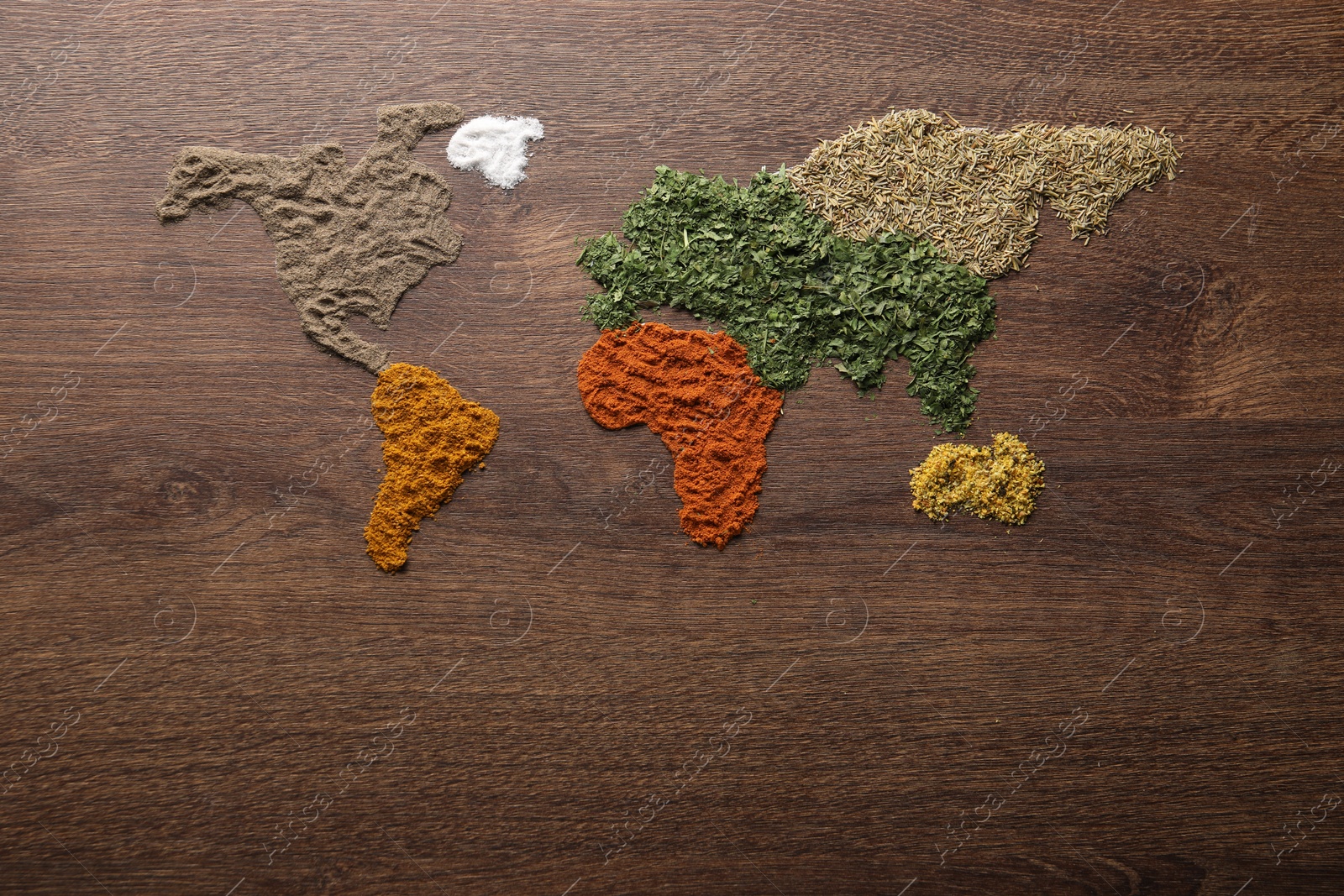 Photo of World map of different spices on wooden table, flat lay