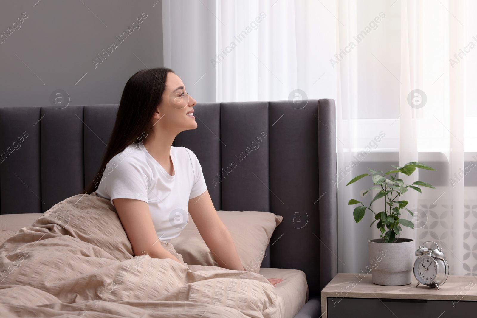 Photo of Beautiful woman in bed at home. Lazy morning