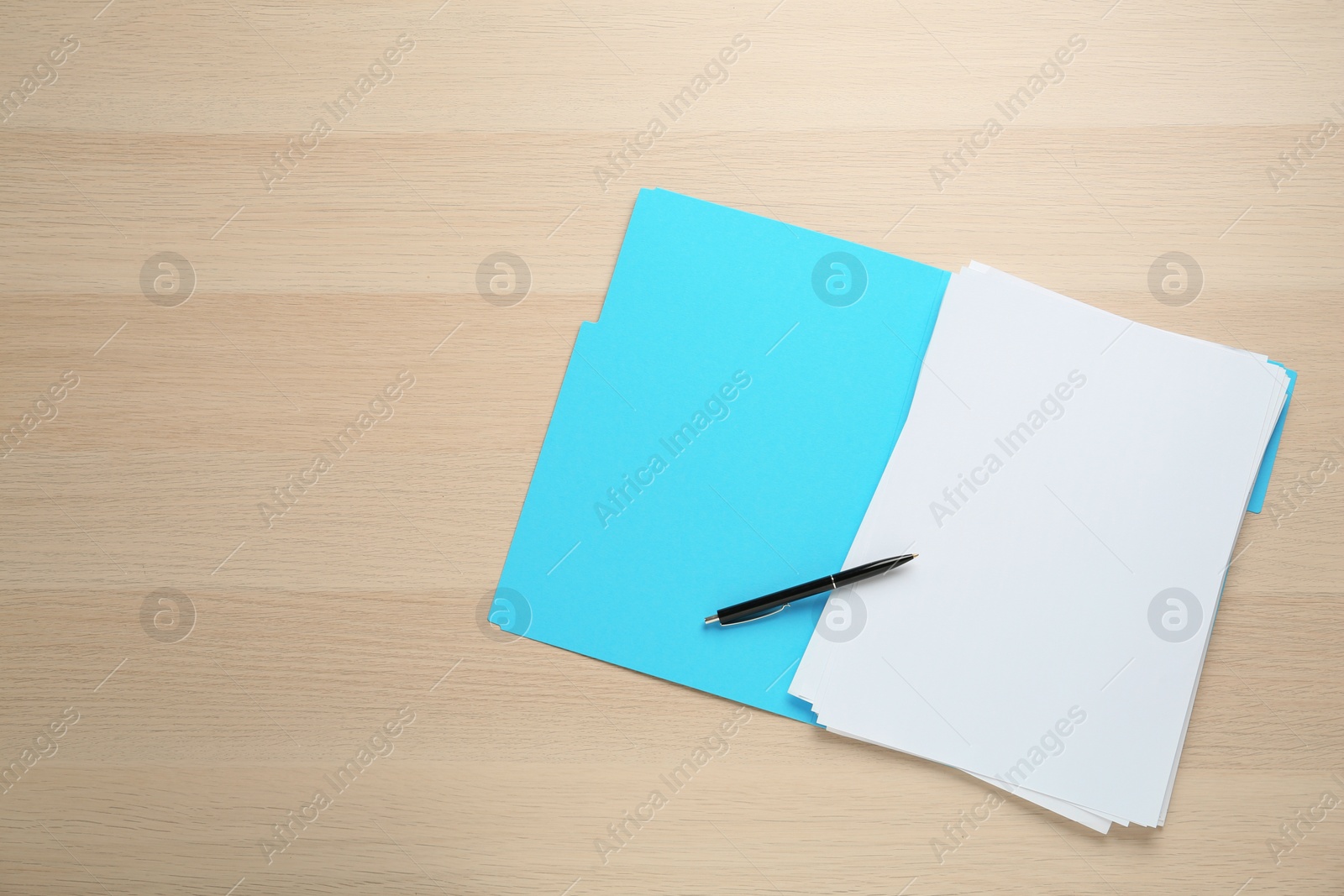 Photo of Turquoise file with blank sheets of paper and pen on wooden table, top view. Space for text