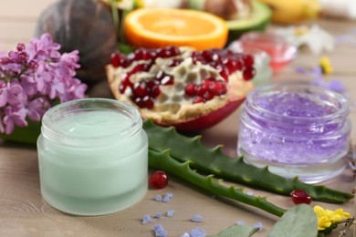 Homemade cosmetic products and fresh ingredients on wooden table, closeup. DIY beauty recipe