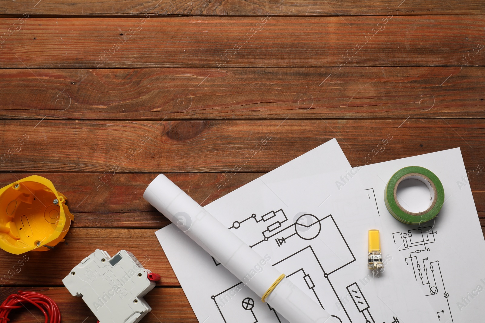 Photo of Flat lay composition with wiring diagrams on wooden table. Space for text