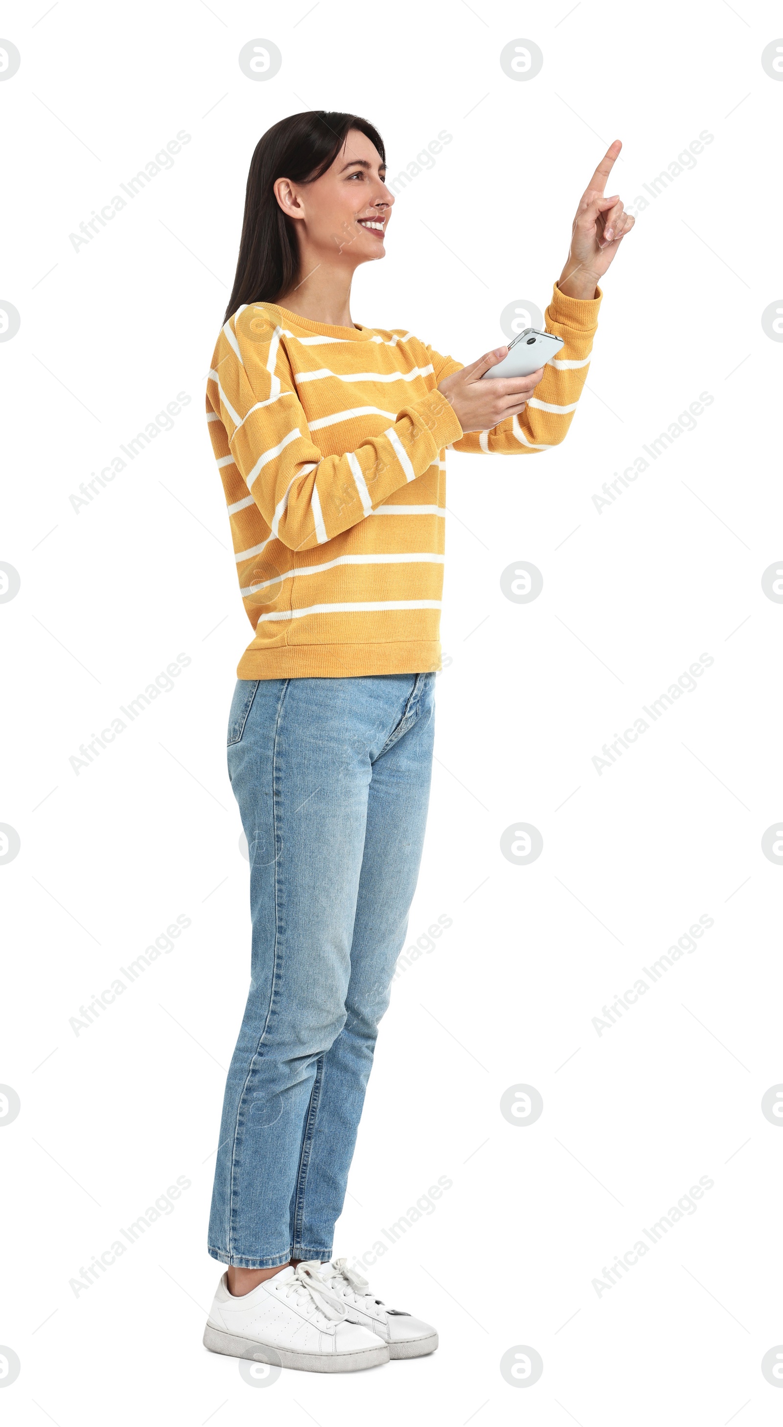 Photo of Happy woman using smartphone and pointing at something on white background
