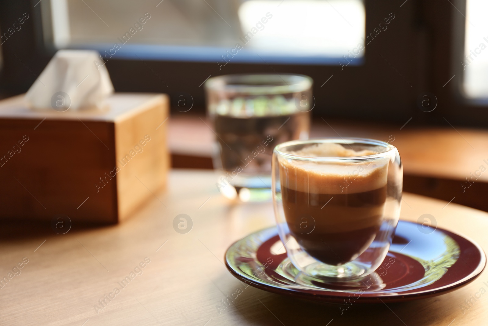 Photo of Aromatic coffee on wooden table in cafe. Space for text