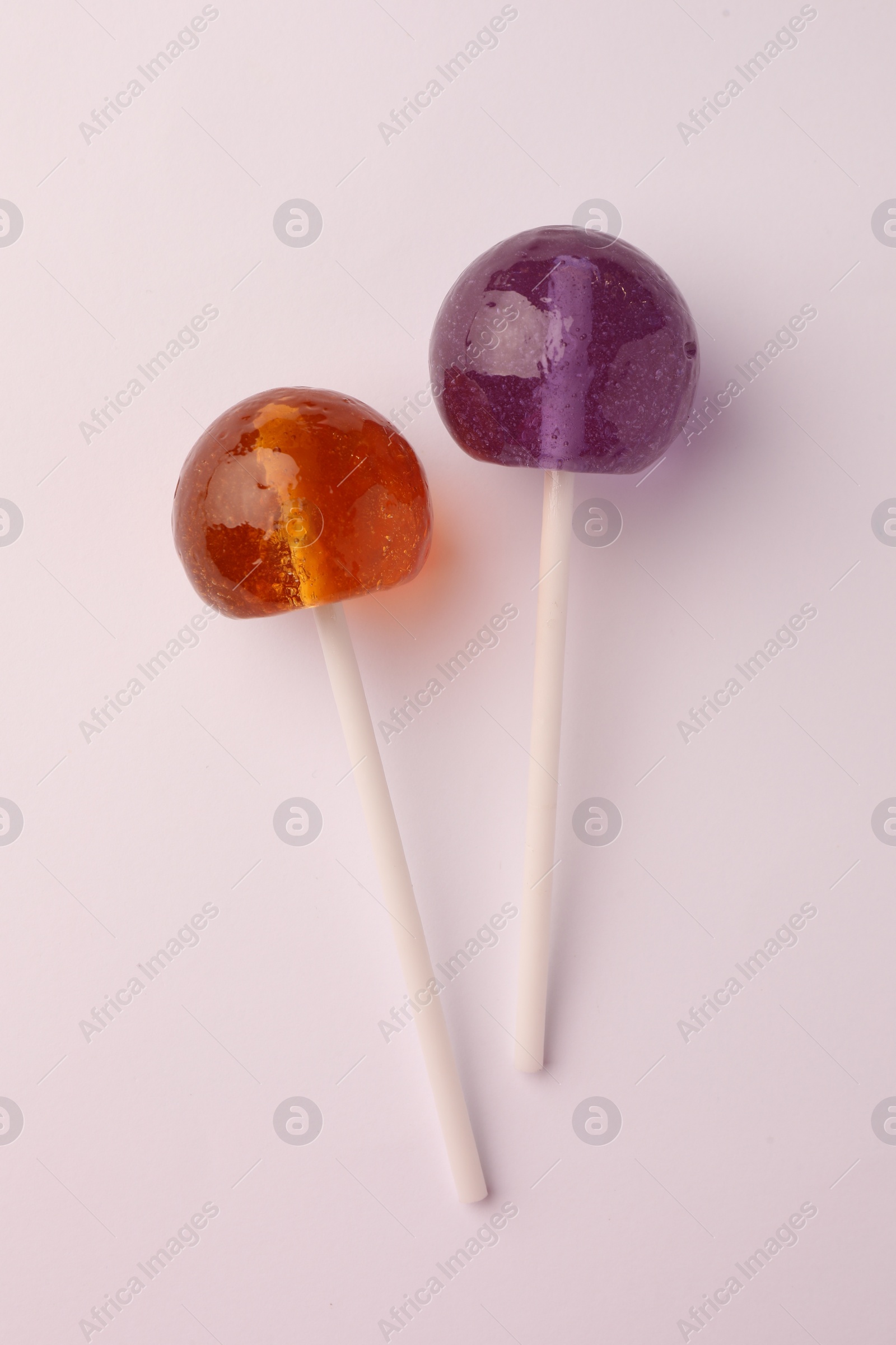 Photo of Tasty lollipops on white background, flat lay