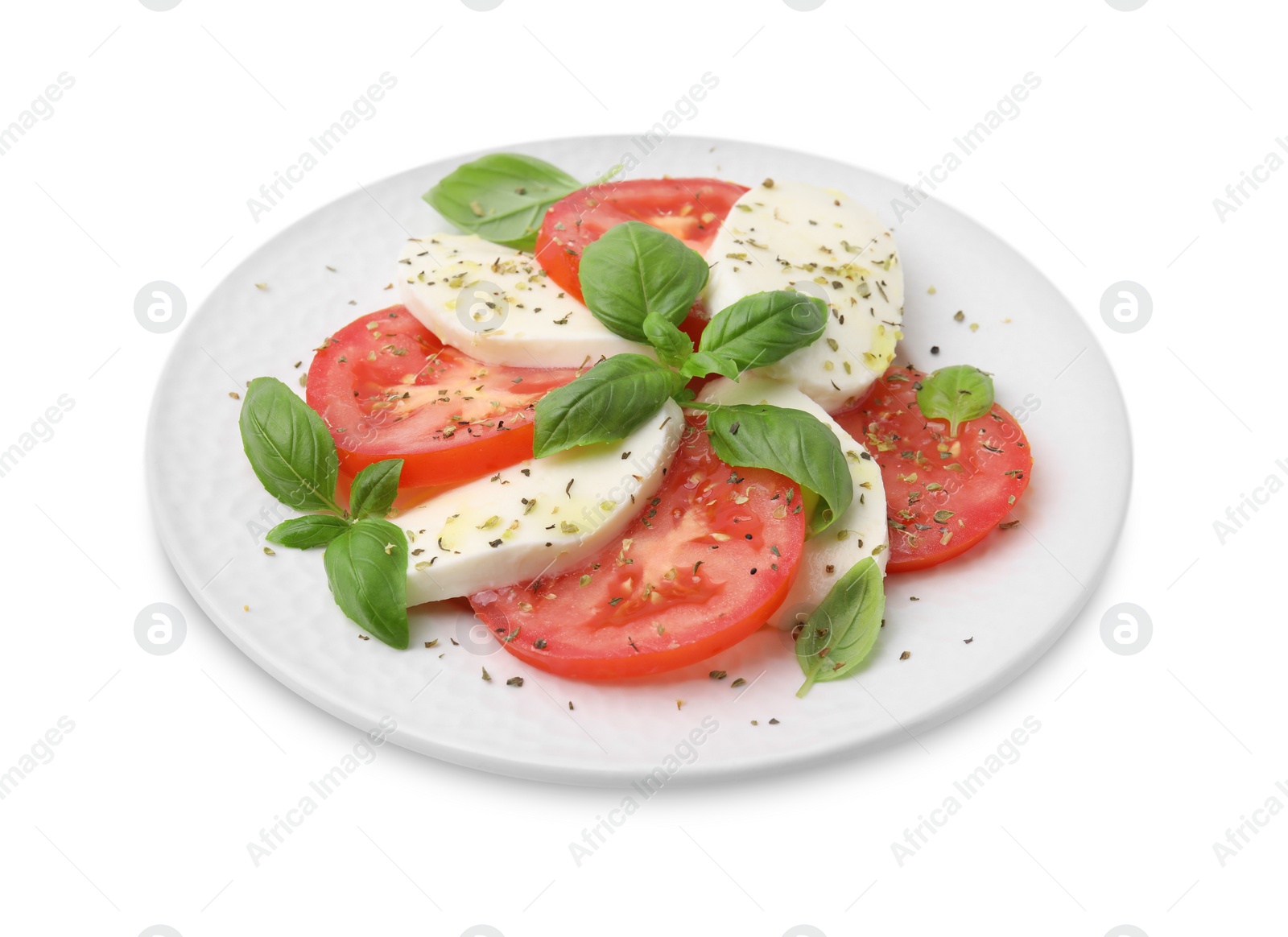 Photo of Plate of delicious Caprese salad with herbs isolated on white