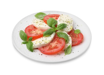 Photo of Plate of delicious Caprese salad with herbs isolated on white