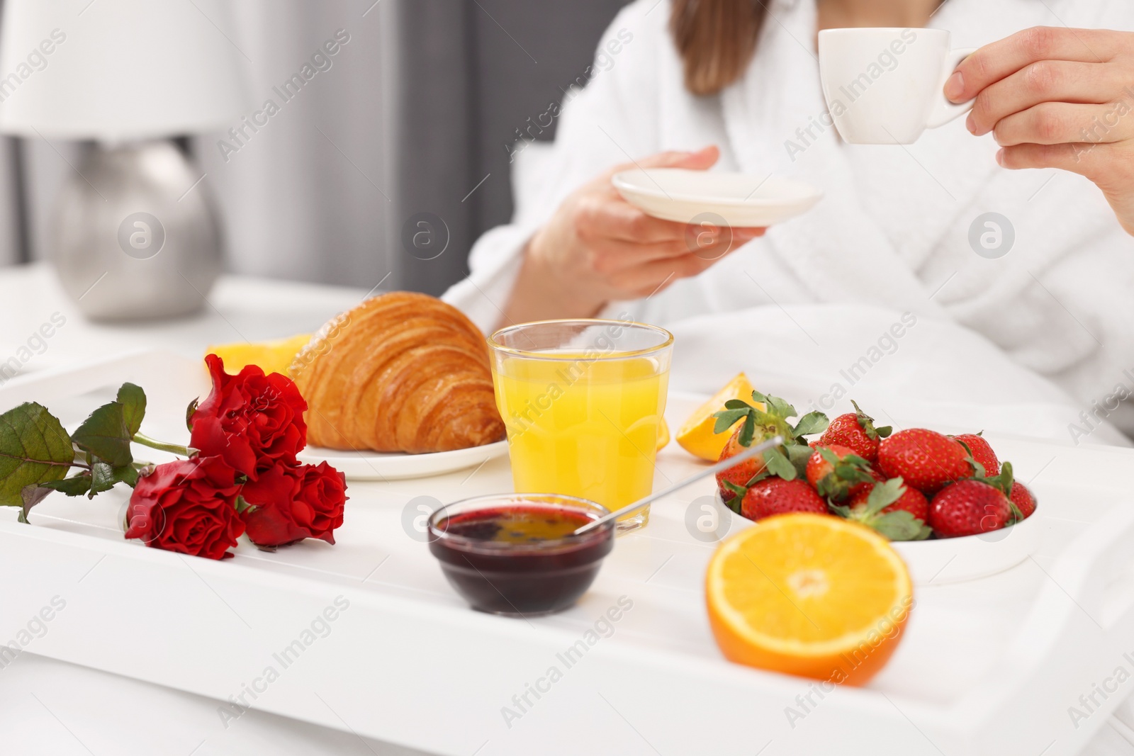 Photo of Woman having breakfast in bed at home, closeup