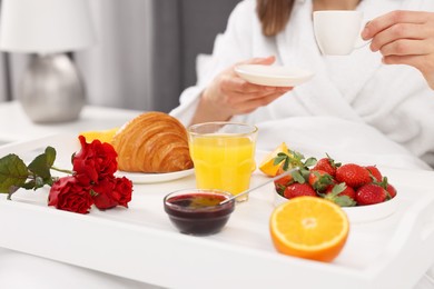 Photo of Woman having breakfast in bed at home, closeup