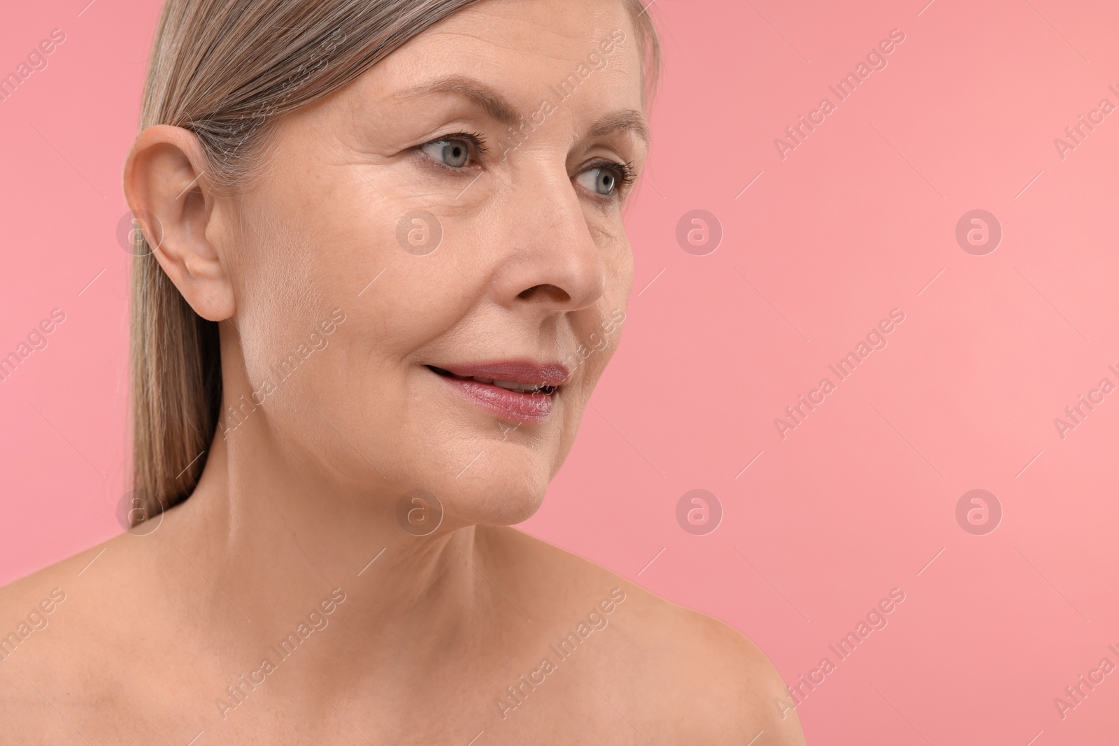 Photo of Beautiful woman with healthy skin on pink background, space for text