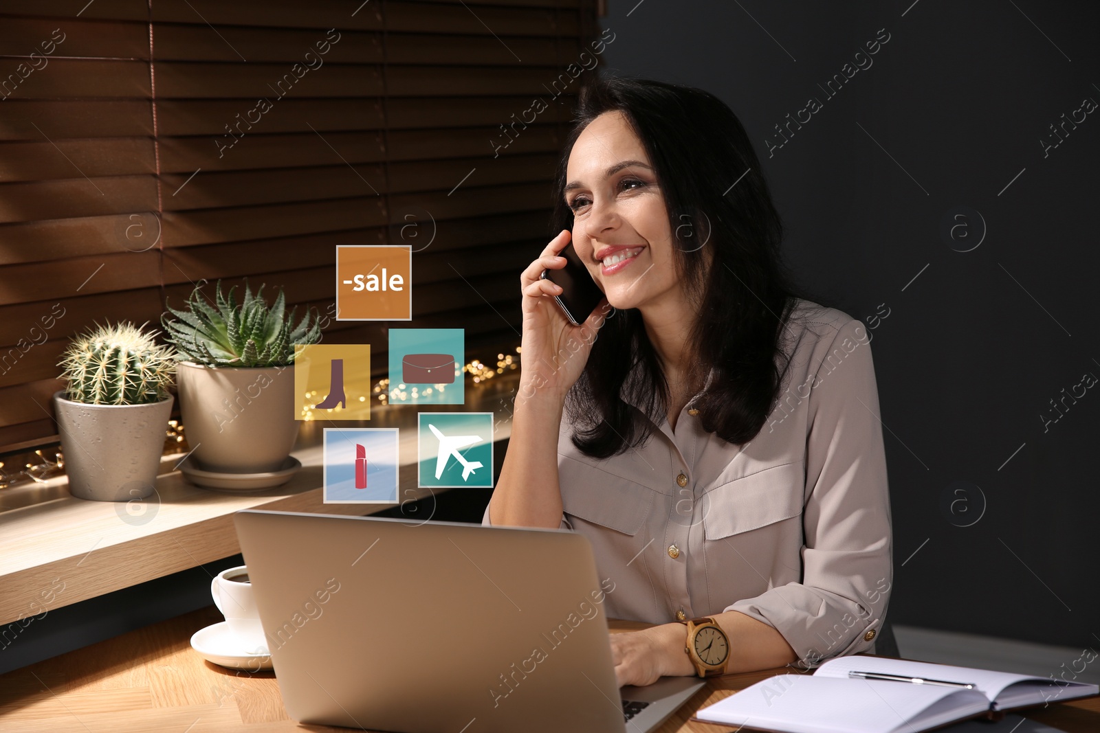 Image of Beautiful woman using laptop at table indoors. Online shopping