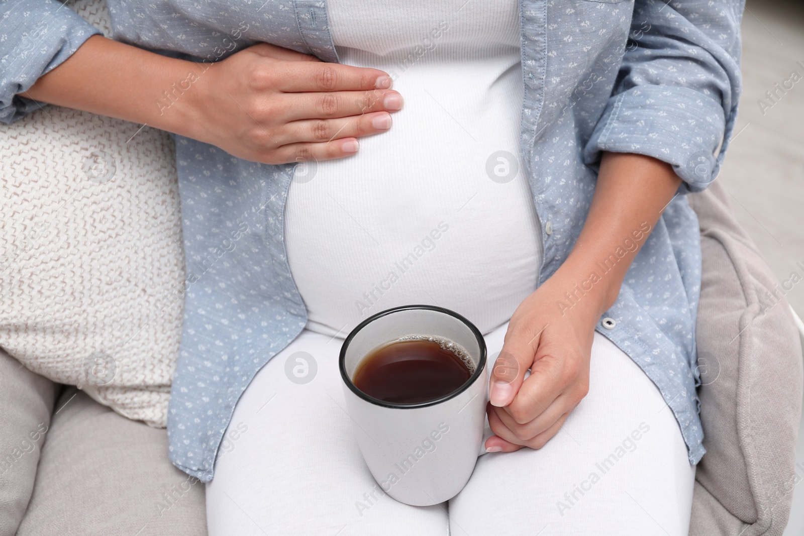 Photo of Pregnant woman drinking tea at home, closeup