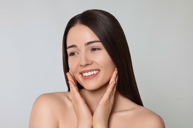 Portrait of attractive young woman on light grey background. Spa treatment